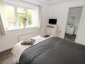 En eller flere senge i et værelse på Butterfly Lodge