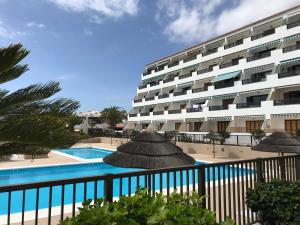 a resort with a swimming pool and a building at Ocean View Apartment Tenerife & Parking WiFi in Costa Del Silencio