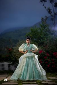 a woman in a dress standing in a yard at PADIKKAL BUNGLOW in Vayittiri