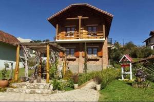 a large house with a porch and a balcony at Claire Cottage in Monte Verde