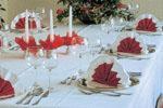 a table with plates and glasses and candles on it at Hotel Rügen Park KG in Gingst