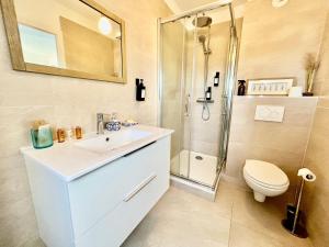 a bathroom with a toilet and a sink and a shower at Un été sans fin à Deauville in Deauville +8 photos