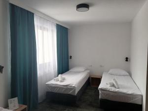Postel nebo postele na pokoji v ubytování Pokoje Hotelowe LUPUS