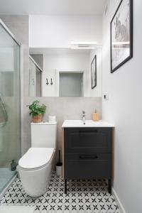 a bathroom with a toilet and a sink and a shower at Patro Apartament 2 Wrocław Centrum in Wrocław +8 photos