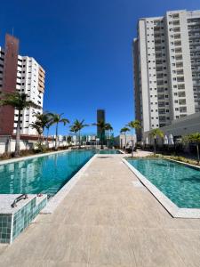 a swimming pool in a city with tall buildings at Reserva 1202 - Hospedagem in Cabedelo