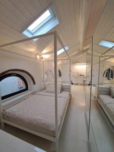 a bedroom with a canopy bed and a window at Cozy Casa Bianca Bergamo in Alzano Lombardo
