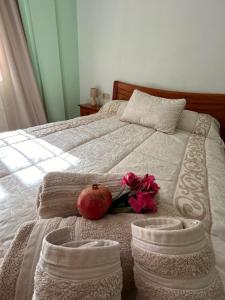 a bed with an apple and flowers on it at Casa Jardín SevillaMia in Orihuela Costa in Orihuela Costa +29 photos
