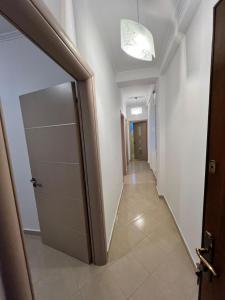 a hallway with a door and a hallway with a mirror at Villa Noah in Berat