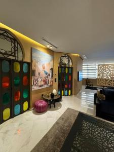 a lobby with a large room with colorful walls at President suite, luxury traditional apartment central in Iberia in Tangier