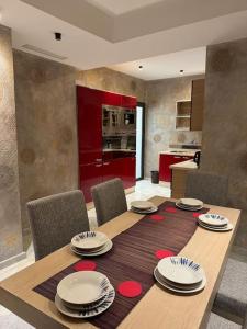 a dining room table with chairs and a kitchen at President suite, luxury traditional apartment central in Iberia in Tangier