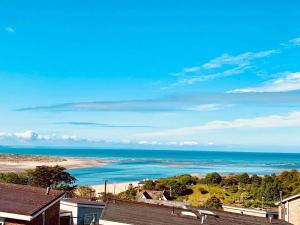 an aerial view of a beach and the ocean at The Glass House in Aberdyfi