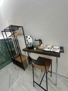 a desk with a chair next to a shelf at Emerald Rooms in Naples