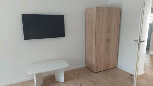 a room with a table and a tv and a wooden cabinet at Haus Blankenagel in Hagen