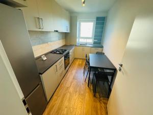 a small kitchen with a table and chairs in it at Milan Luxury Apartaments VII-Târgu Mureș#Maurer Residence in Târgu-Mureş