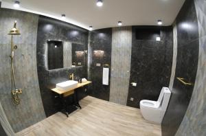 a bathroom with a toilet and a sink at Lu-Na Home in Gomkʼ
