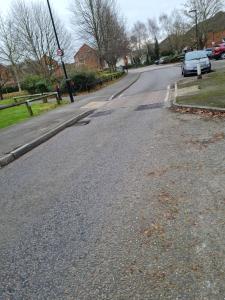 an empty street with a car parked on the road at 75 Park Prewett in Basingstoke