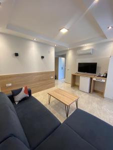 a living room with a blue couch and a table at The Brothers Suite Dalaman in Dalaman