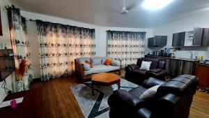 a living room with two couches and a table at Seaesta 2 bedroom b at Savannah in Ukunda