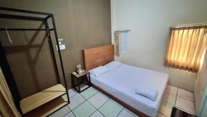 Postel nebo postele na pokoji v ubytování Wisma Alamanda + 28 fotografií
