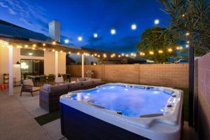 a large hot tub in a backyard with lights at Glendale Nights - Pool Hot Tub Put Put Foosball in Glendale