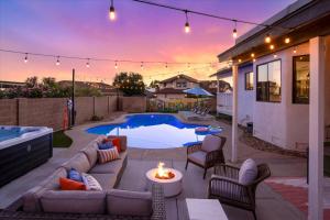 a backyard with a pool with a couch and a fire pit at Glendale Nights - Pool Hot Tub Put Put Foosball in Glendale