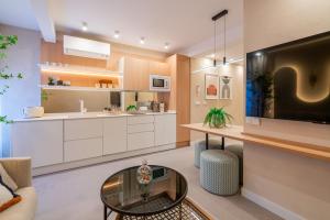 a living room with a tv and a table at WOW APARTAMENTOS VALLADOLID in Valladolid