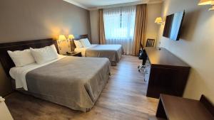 Postel nebo postele na pokoji v ubytování Hotel Diego de Almagro Coyhaique