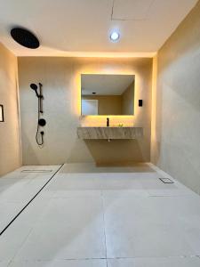 a bathroom with a sink and a shower and a mirror at Damac Apartment شقة مع جاكوزي بإطلالة بحرية in Jeddah +13 photos