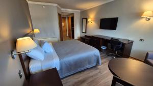 Postel nebo postele na pokoji v ubytování Hotel Diego de Almagro Coyhaique