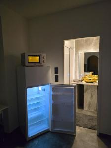 a kitchen with a refrigerator with a microwave on top at Rentcenter79 in Donawitz +16 photos