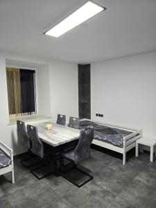 a room with a table and chairs and a bed at Rentcenter79 in Donawitz