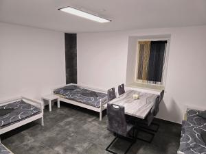 a room with two beds and a table and chairs at Rentcenter79 in Donawitz +16 photos