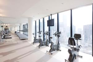 a gym with treadmills and elliptical machines at Crown Metropol Melbourne in Melbourne