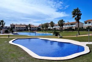 a large blue swimming pool with buildings in the background at Tu Lugar Soñado-Lifestyle Premium Pool-Confort in Sant Jordi