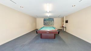 a room with a pool table in the middle of it at Stunning 1-Bedroom Condo in the Heart of Vancouver in Vancouver