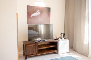 a living room with a tv on a wooden stand at Apartamenty Castello in Kluczbork