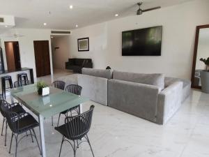 a living room with a couch and a table at Secret Waters 104 in Puerto Aventuras