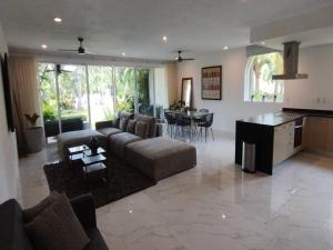 a large living room with a couch and a table at Secret Waters 104 in Puerto Aventuras