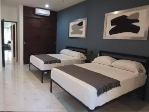 two beds in a room with blue walls at Secret Waters 104 in Puerto Aventuras +22 photos
