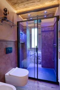 a bathroom with a shower with a toilet and a glass door at La Certosa in Chiusa di Pesio