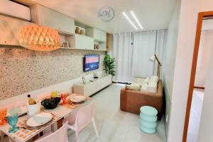 a living room with a dining table and a couch at Flat Patacho - Rota Ecológica dos Milagres in Pôrto de Pedras