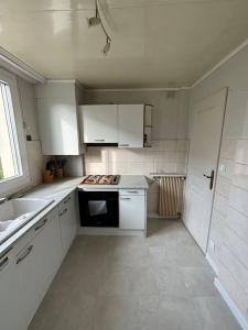 a white kitchen with a sink and a stove at Appartement T3 Cagnes sur Mer in Cagnes-sur-Mer +5 photos