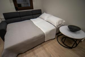 a bed with a black headboard and a side table at "Meteora Magic" apartments in Kalabaka +39 photos