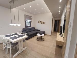 a living room with a couch and a table at "Meteora Magic" apartments in Kalabaka