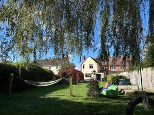 un'amaca in mezzo a un cortile con case di King Arthur's Rest House, Hot Tub & Garden Sleeps 10 a South Cadbury