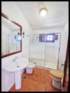 a bathroom with a sink and a toilet and a shower at Casa Rural Faustina in Isora +20 photos