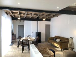 a living room with a table and a couch at Bruisse in Les Iffs +34 photos