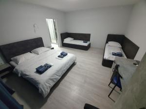a room with two beds and a table in it at HotelRoom 27 in Uzhhorod