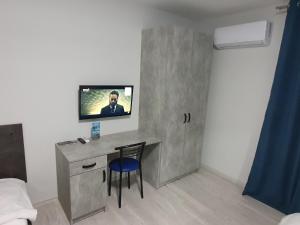 a room with a desk and a tv on a wall at HotelRoom 27 in Uzhhorod