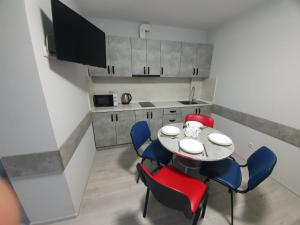 a dining room with a table and chairs and a kitchen at HotelRoom 27 in Uzhhorod